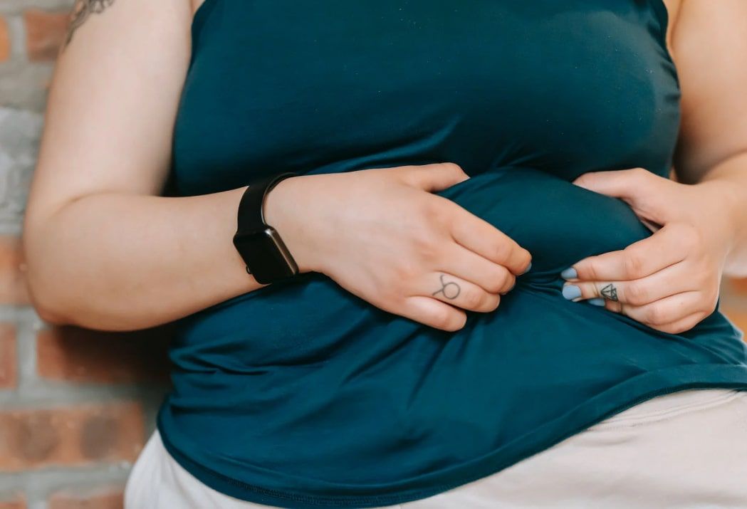 dry fasting and electrolytes obese woman holding her stomach