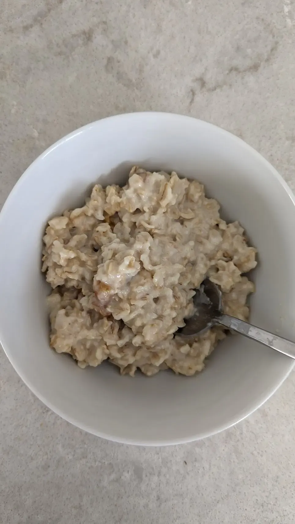 bowl of oatmeal with dried fruits apricot after fasting