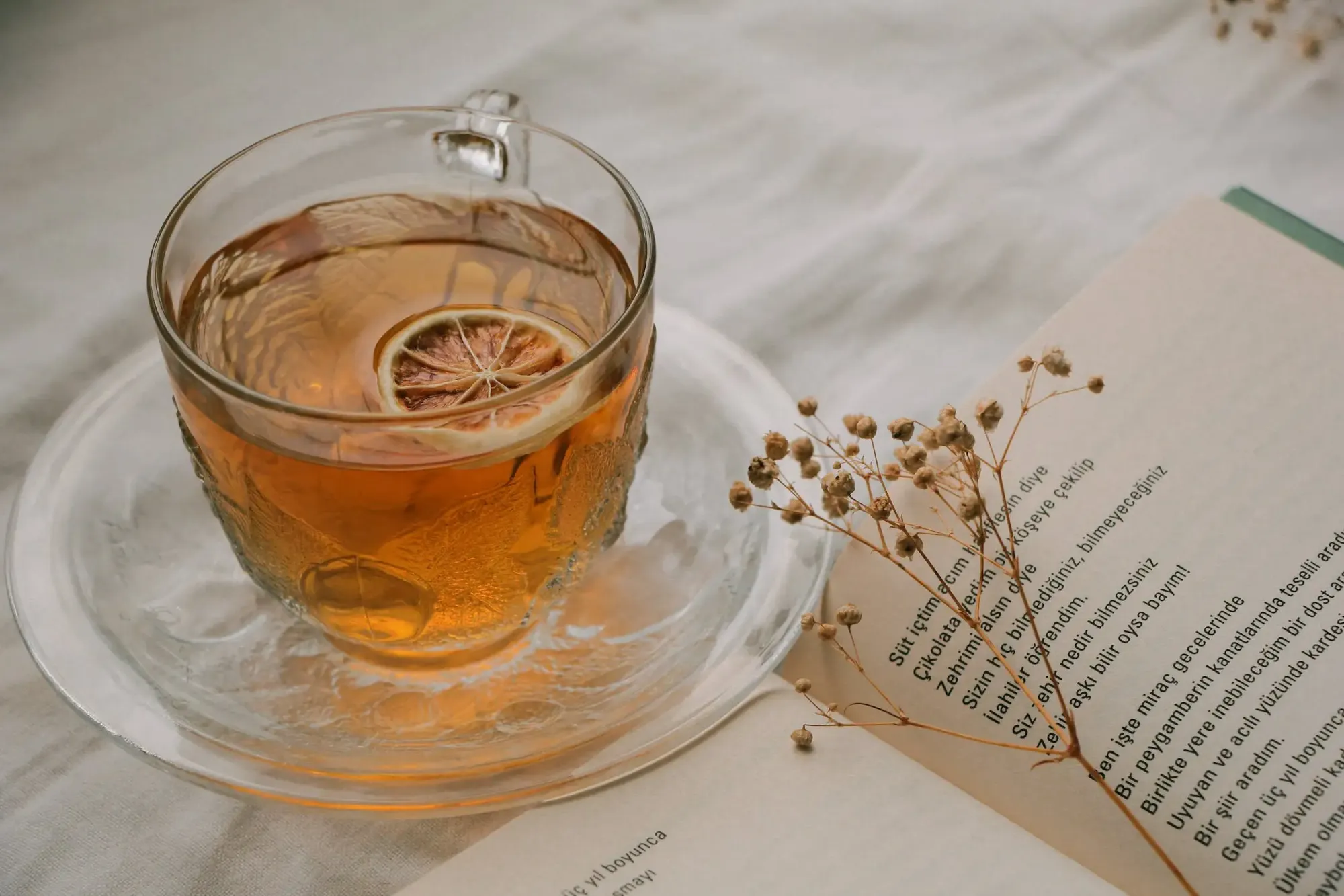 a see through glass cup with tea inside