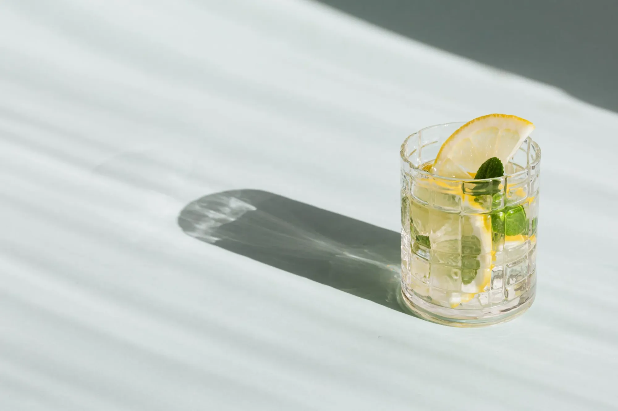 lemon water and cut lemons on wooden board